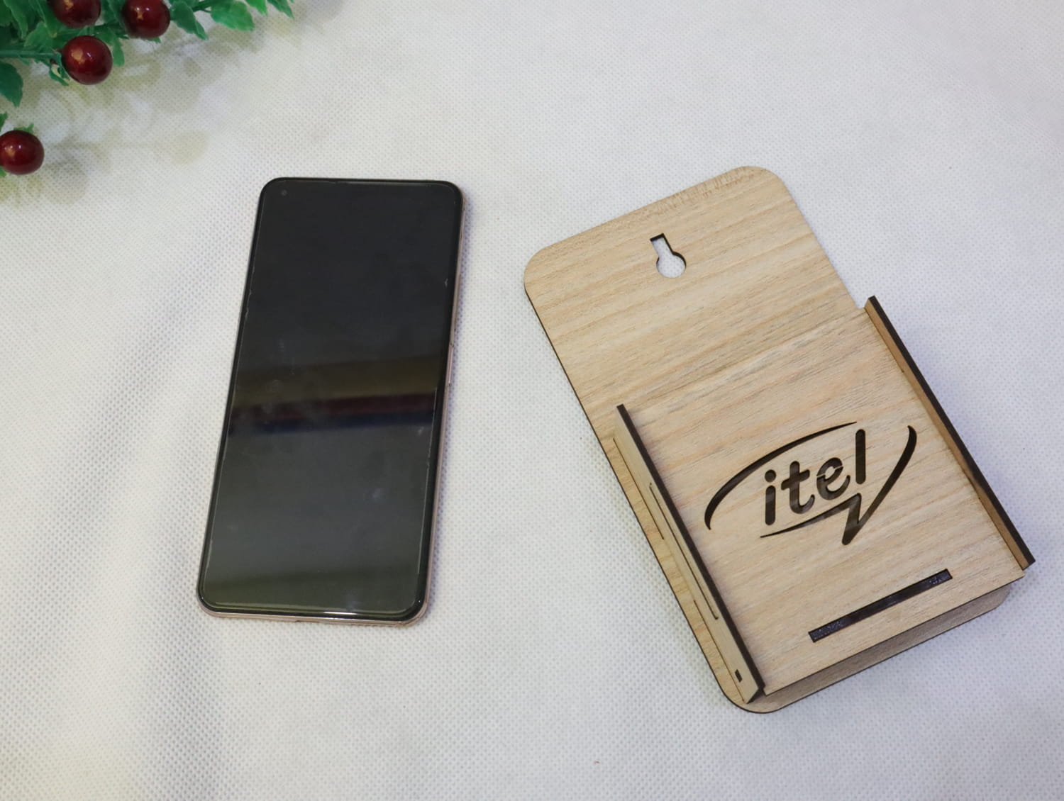 Laser Cut Wall Mounted Mobile Holder With Itel Logo Free Vector